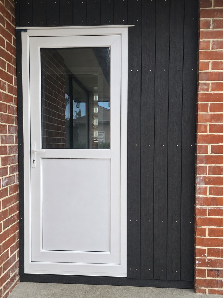 New white uPVC entrance door fitted to a brick home
