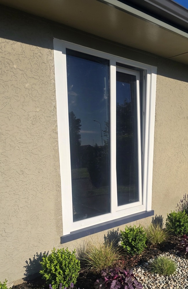 White uPVC tilt and turn window in the tilt position for secure ventilation